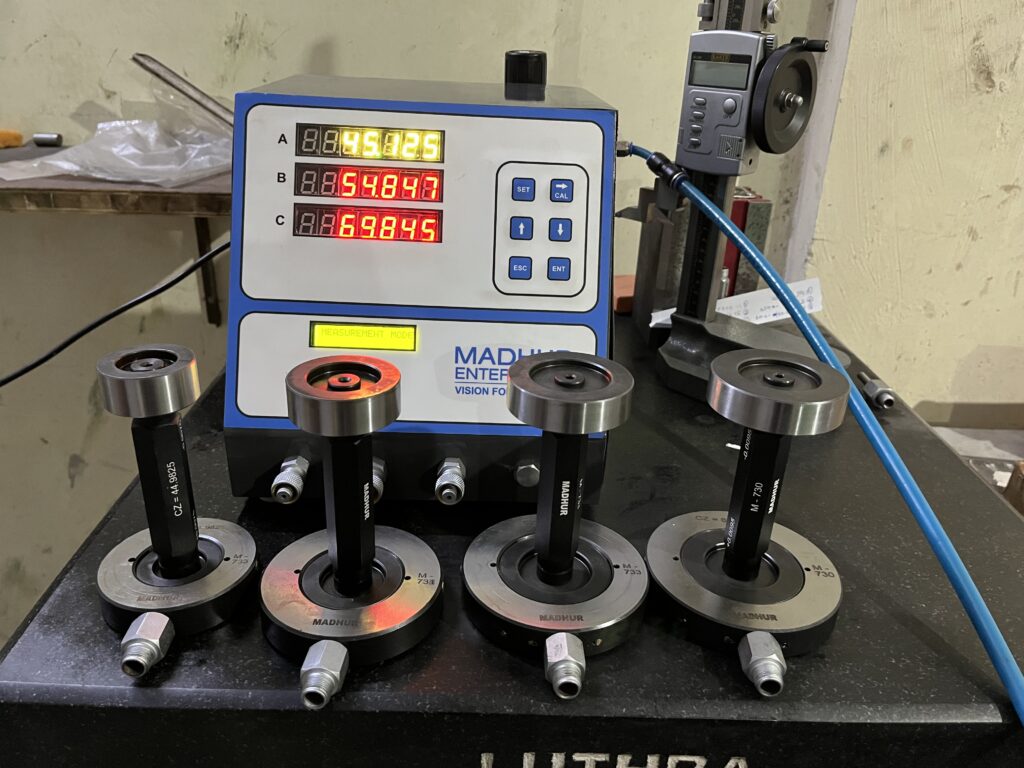 Digital air gauge unit with electronic display for high-precision measurement in production.